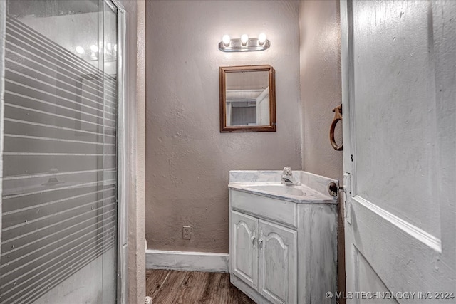 bathroom with hardwood / wood-style floors and vanity