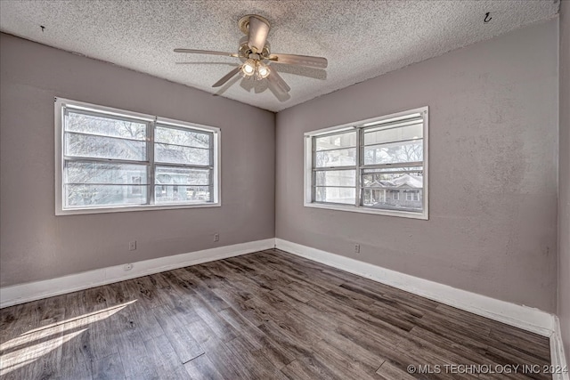 empty room featuring dark hardwood / wood-style flooring, a textured ceiling, and ceiling fan