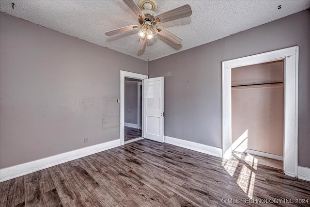 unfurnished bedroom with ceiling fan, a closet, wood-type flooring, and a textured ceiling