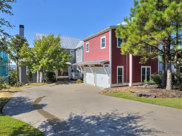 86 Ridgeline, Carlton Landing, OK 74432 - view of front of home featuring an attached garage, a porch, and concrete driveway