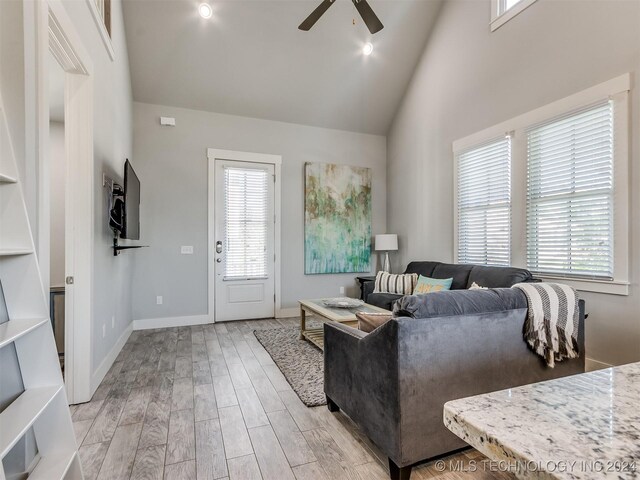 86 Ridgeline, Carlton Landing, OK 74432 - living room with baseboards, light wood finished floors, high vaulted ceiling, and ceiling fan