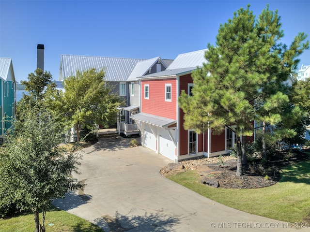 view of front of house with a garage and a front lawn