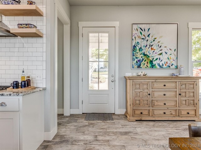 86 Ridgeline, Carlton Landing, OK 74432 - doorway featuring light wood-style floors and baseboards