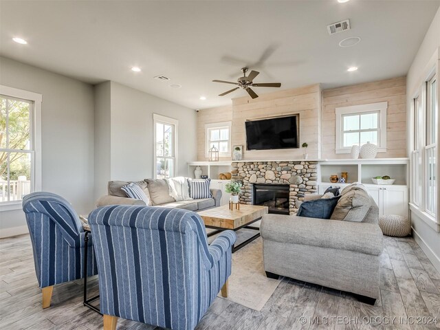 86 Ridgeline, Carlton Landing, OK 74432 - living room featuring plenty of natural light, ceiling fan, light wood finished floors, a fireplace, and visible vents