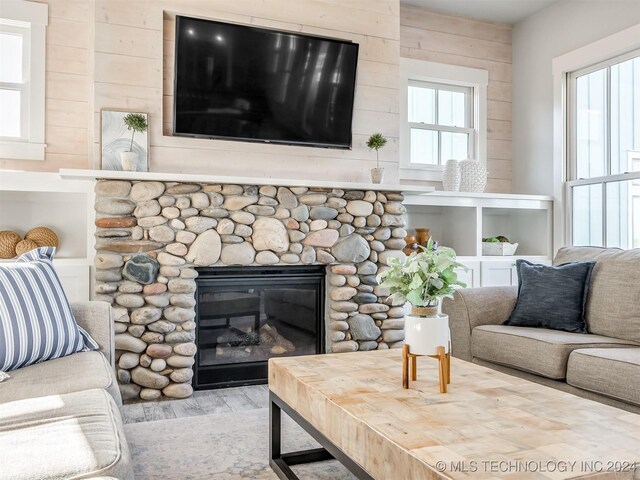 86 Ridgeline, Carlton Landing, OK 74432 - living area with wood walls and a fireplace