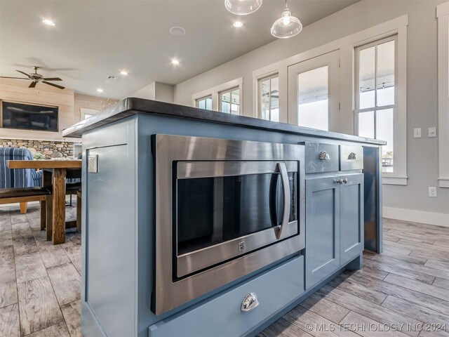 86 Ridgeline, Carlton Landing, OK 74432 - details featuring stainless steel microwave, baseboards, recessed lighting, light wood-style floors, and ceiling fan