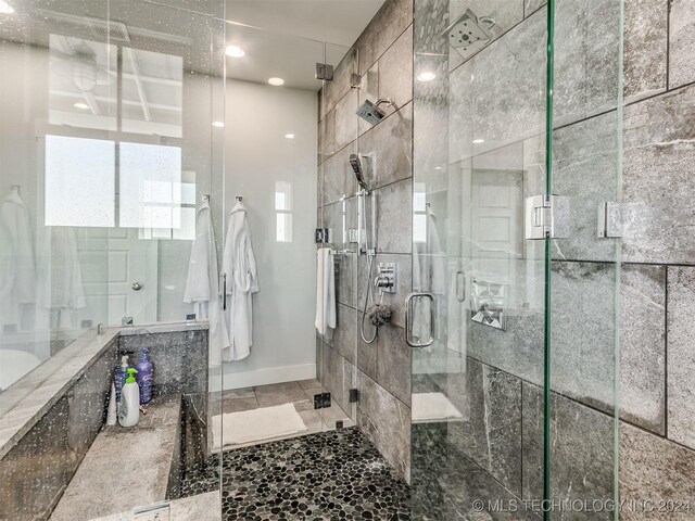 86 Ridgeline, Carlton Landing, OK 74432 - bathroom featuring recessed lighting, a shower stall, stone finish flooring, and baseboards