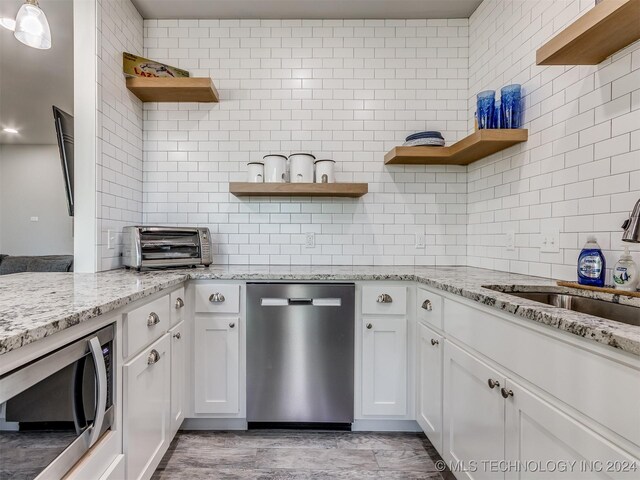86 Ridgeline, Carlton Landing, OK 74432 - kitchen featuring tasteful backsplash, open shelves, a sink, a toaster, and appliances with stainless steel finishes
