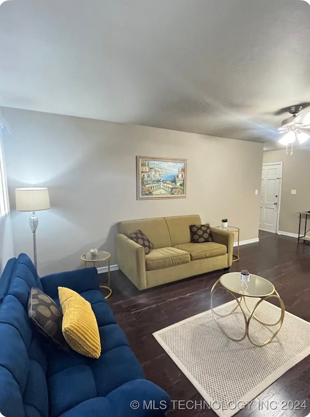 living room with ceiling fan and dark hardwood / wood-style flooring