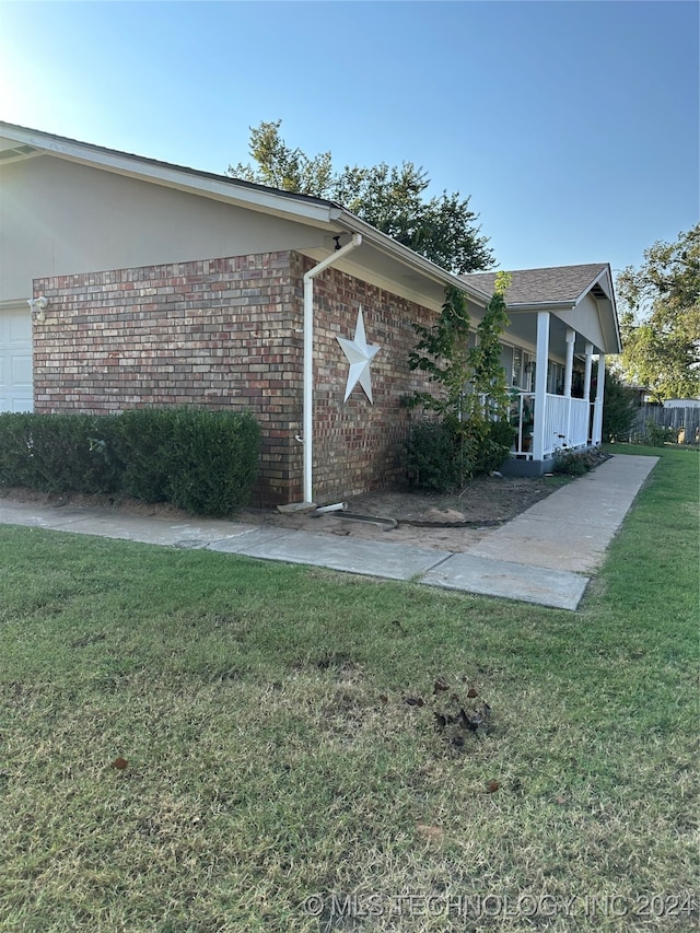 view of side of property with a lawn