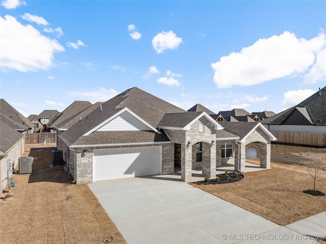 2804 E Northampton St, Broken Arrow, OK 74014 - french country home with a shingled roof, a garage, driveway, brick siding, and cooling unit