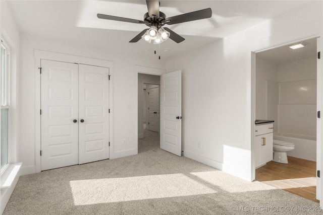 2804 E Northampton St, Broken Arrow, OK 74014 - unfurnished bedroom with a closet, light colored carpet, connected bathroom, and a ceiling fan