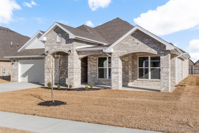 2804 E Northampton St, Broken Arrow, OK 74014 - french country inspired facade featuring a garage, brick siding, driveway, roof with shingles, and a front yard