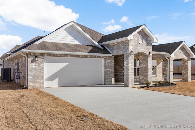 2804 E Northampton St, Broken Arrow, OK 74014 - view of front of home with brick siding, an attached garage, driveway, and roof with shingles
