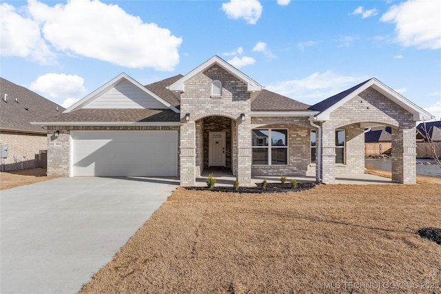2804 E Northampton St, Broken Arrow, OK 74014 - french country home featuring brick siding, a shingled roof, and an attached garage
