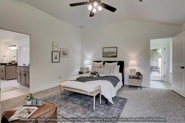 bedroom with ceiling fan, light hardwood / wood-style flooring, ensuite bath, vaulted ceiling, and access to outside