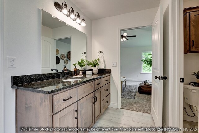 bathroom featuring ceiling fan, vanity, and toilet