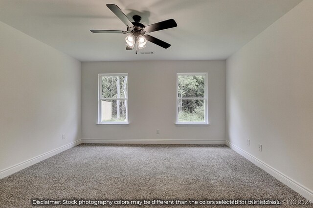 unfurnished room featuring ceiling fan, plenty of natural light, and carpet