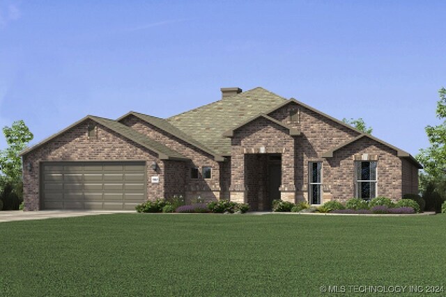 view of front of property with a garage and a front yard