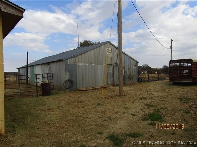view of pole building featuring fence