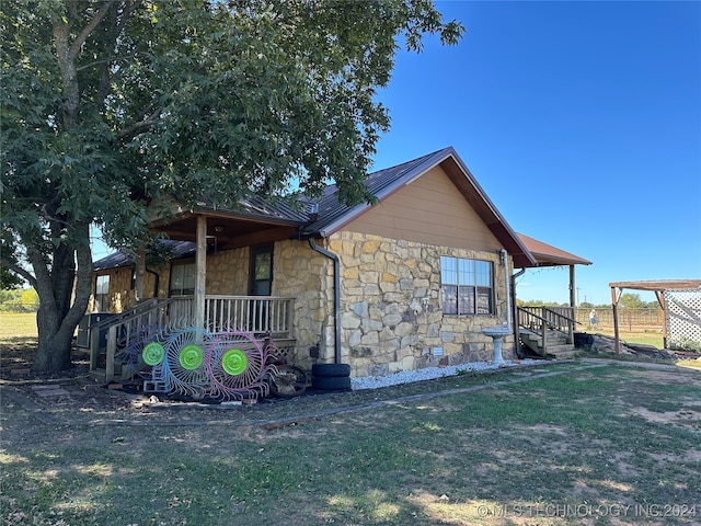 exterior space featuring a yard and covered porch