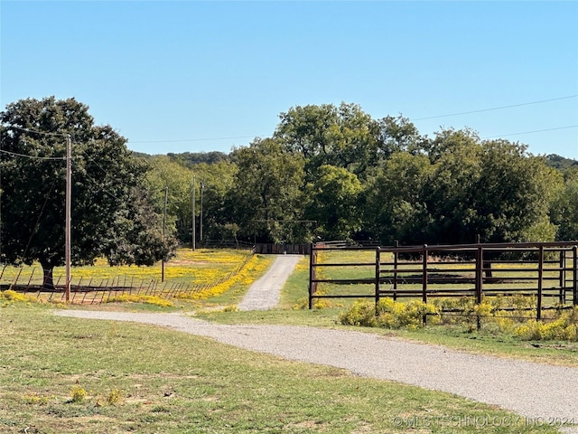 view of street featuring a rural view and a view of trees