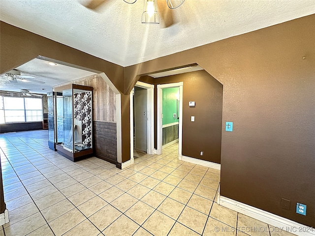 interior space featuring ceiling fan and a textured ceiling