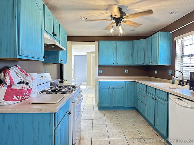 kitchen with a sink, under cabinet range hood, blue cabinetry, a ceiling fan, and white appliances