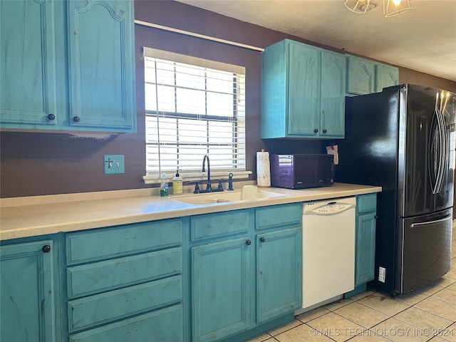 kitchen with dishwasher, black refrigerator, blue cabinetry, sink, and light tile patterned floors