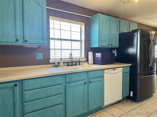 kitchen featuring a sink, light tile patterned flooring, white dishwasher, black microwave, and blue cabinets