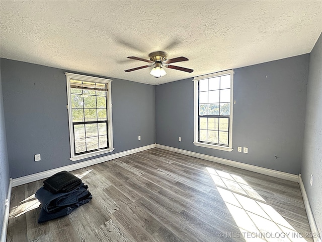 unfurnished room featuring wood-type flooring, a textured ceiling, and ceiling fan