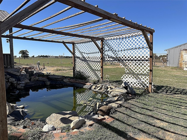 view of yard with a garden pond and a pergola