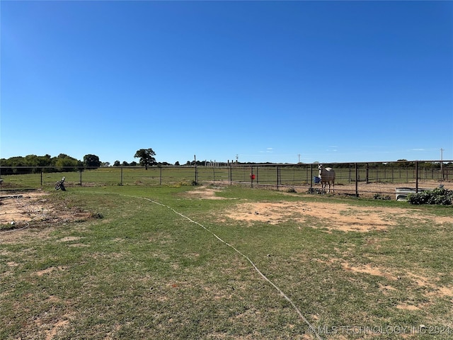 view of yard featuring fence and a rural view