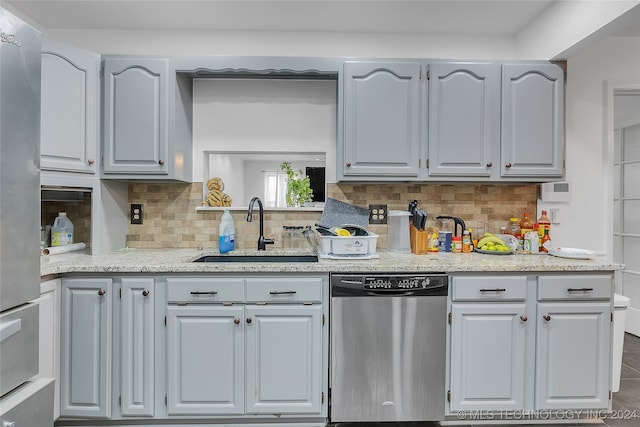 kitchen featuring gray cabinetry, decorative backsplash, sink, and stainless steel appliances