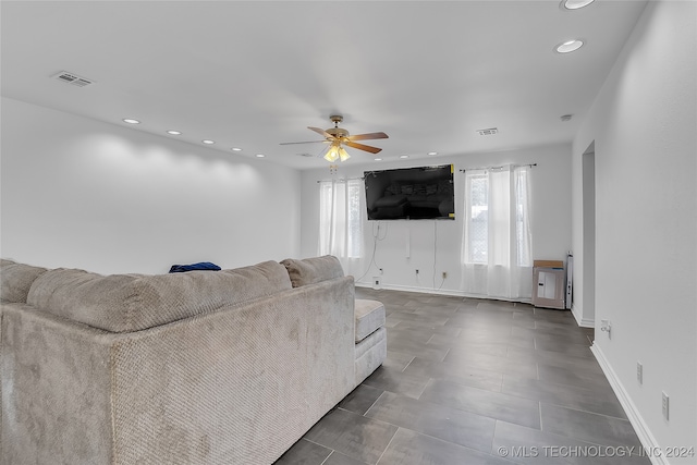 unfurnished living room featuring ceiling fan