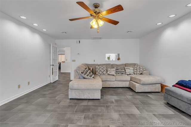 living room with ceiling fan and french doors