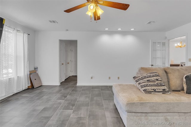 sitting room featuring ceiling fan with notable chandelier