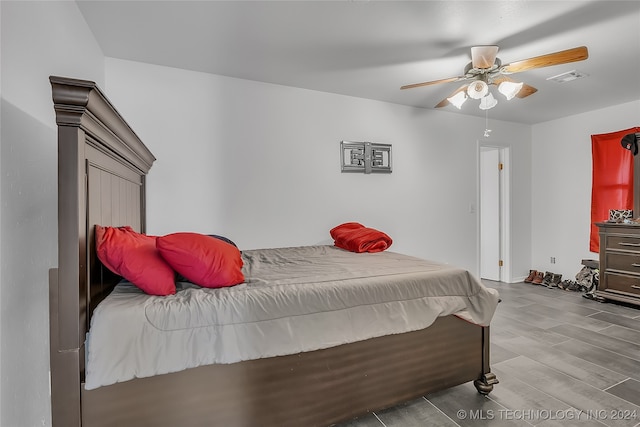 bedroom with ceiling fan and light hardwood / wood-style flooring