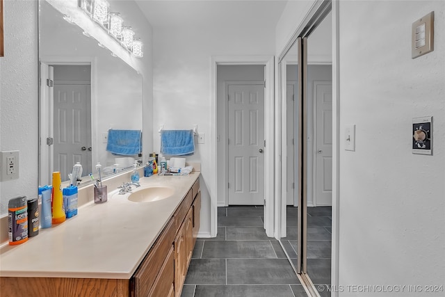 bathroom with vanity and tile patterned flooring