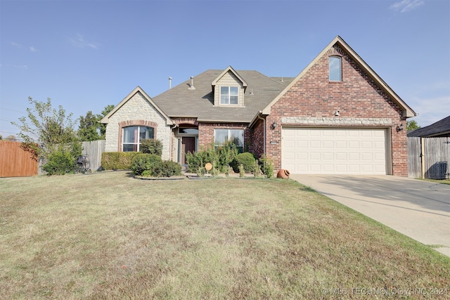 view of front of home featuring a garage and a front yard