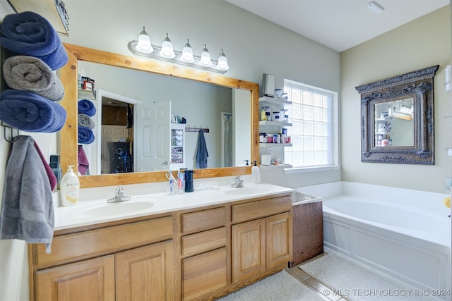 bathroom featuring vanity and a bath