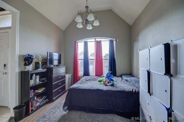 bedroom with light wood-type flooring, vaulted ceiling, and a notable chandelier