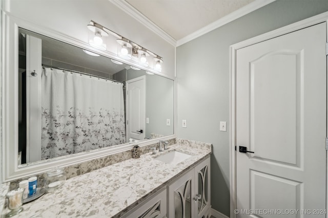 bathroom featuring a shower with shower curtain, ornamental molding, and vanity