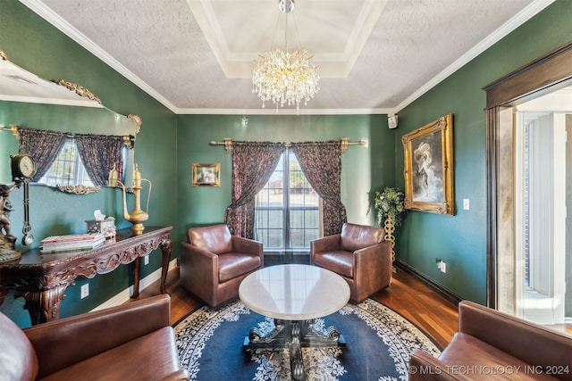 sitting room featuring a wealth of natural light, a notable chandelier, a textured ceiling, and wood finished floors