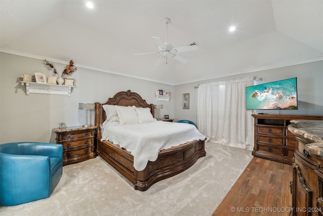 bedroom with a ceiling fan, lofted ceiling, wood finished floors, and ornamental molding