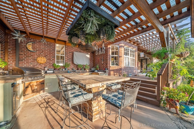 view of patio featuring outdoor wet bar, exterior kitchen, a pergola, and grilling area