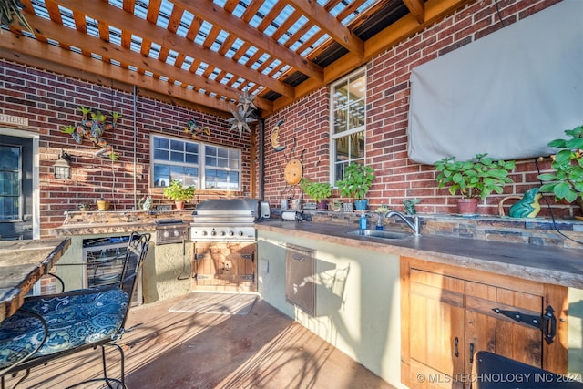 view of patio featuring a sink, area for grilling, a pergola, and a grill