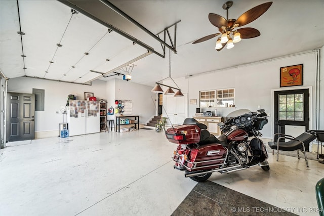 garage featuring electric panel, a garage door opener, and a ceiling fan