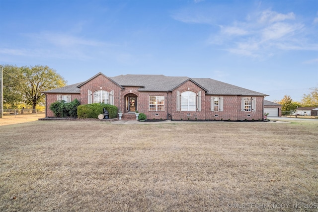 single story home featuring crawl space, brick siding, and a front yard