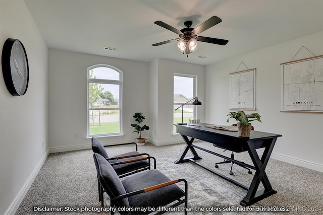 carpeted home office with ceiling fan